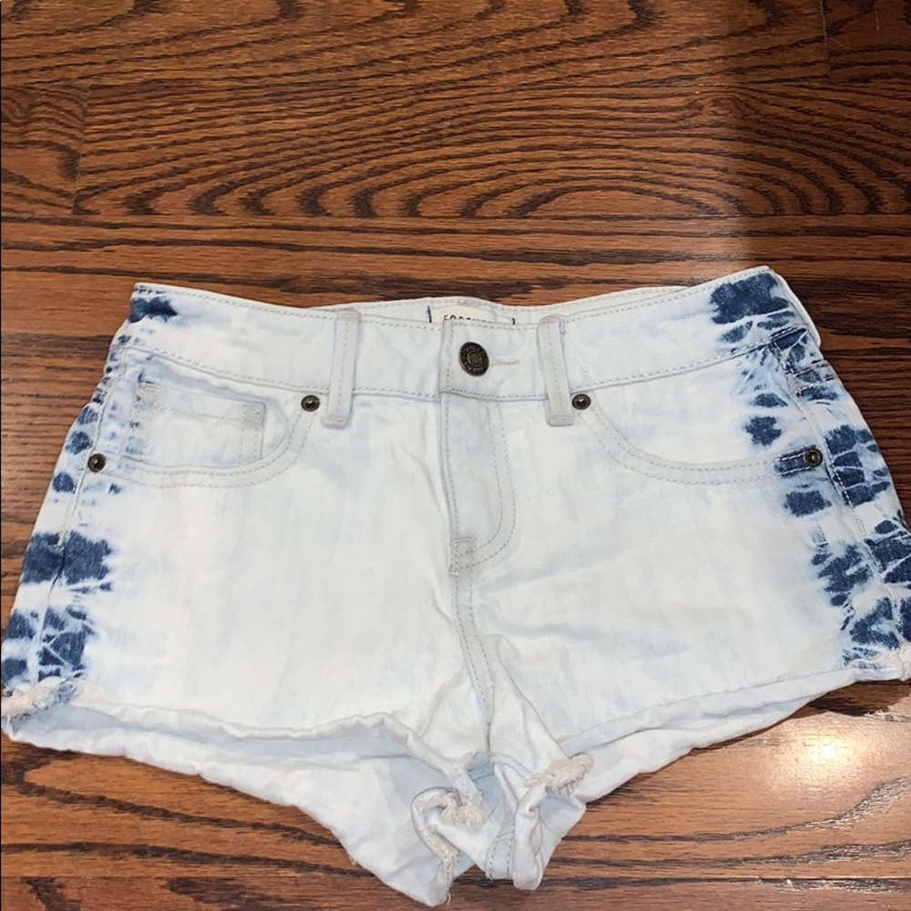 White shorts with blue on the side.